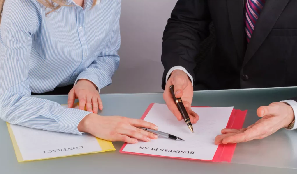 businessman-and-businesswoman-working-with-document