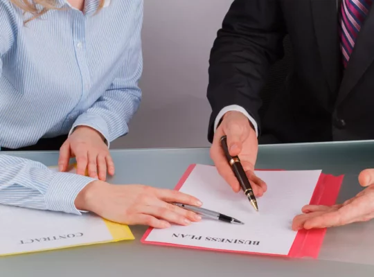 businessman-and-businesswoman-working-with-document