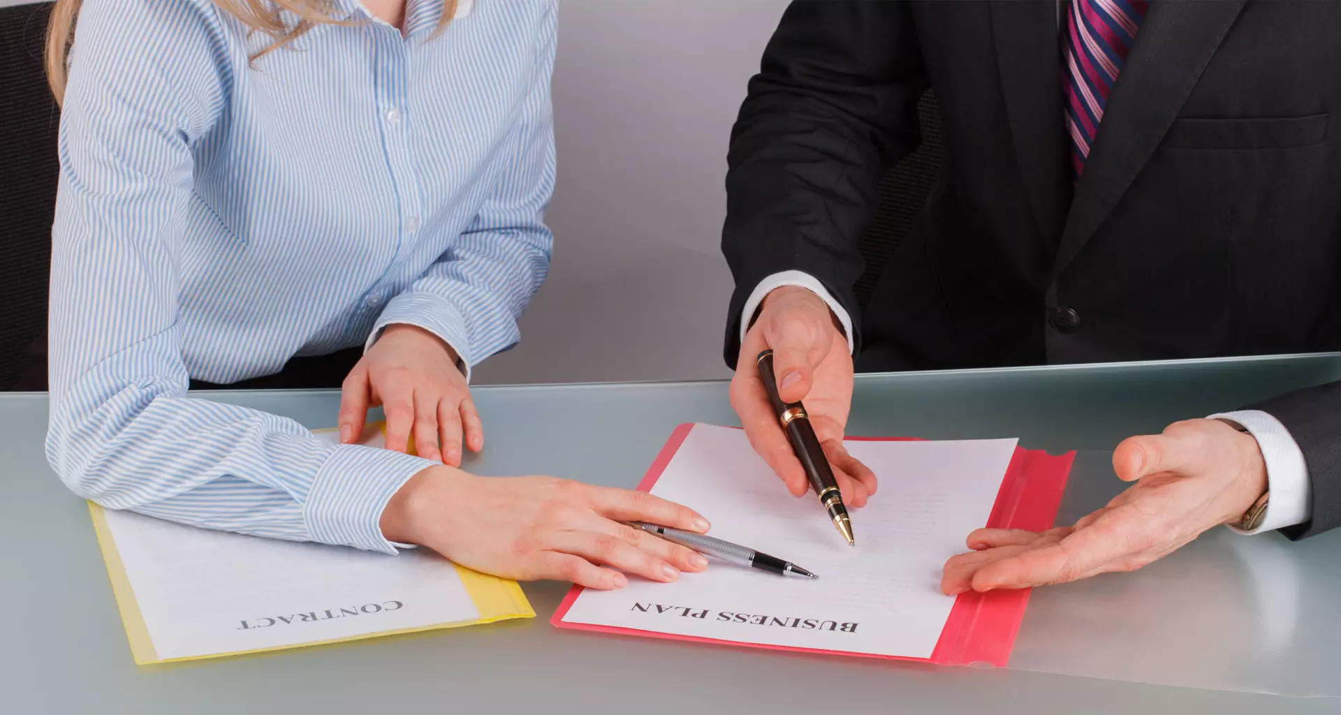 businessman-and-businesswoman-working-with-document